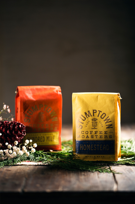 An orange and yellow bag of Stumptown Coffee grounds.
