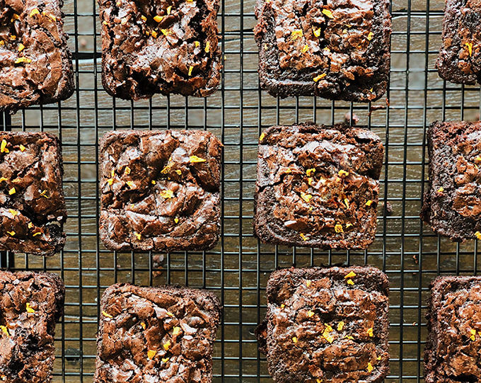 Brownie squares arranged on a cooling rack.