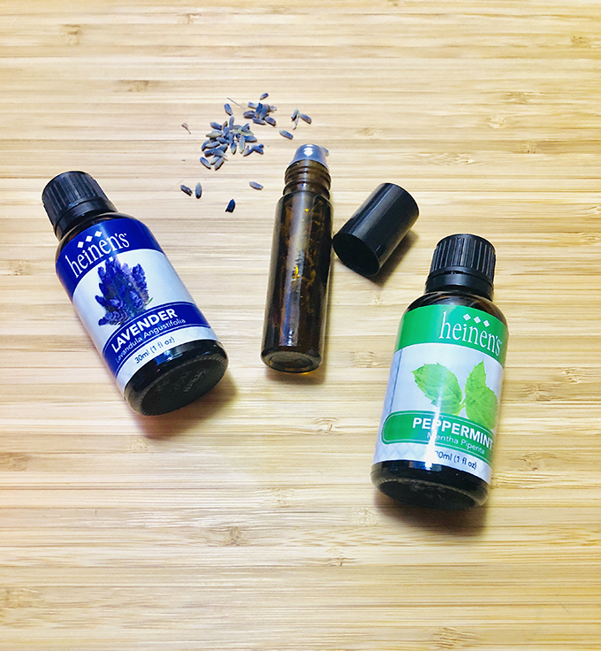 Heinen's lavender essential oil bottle next to Heinen's peppermint oil.