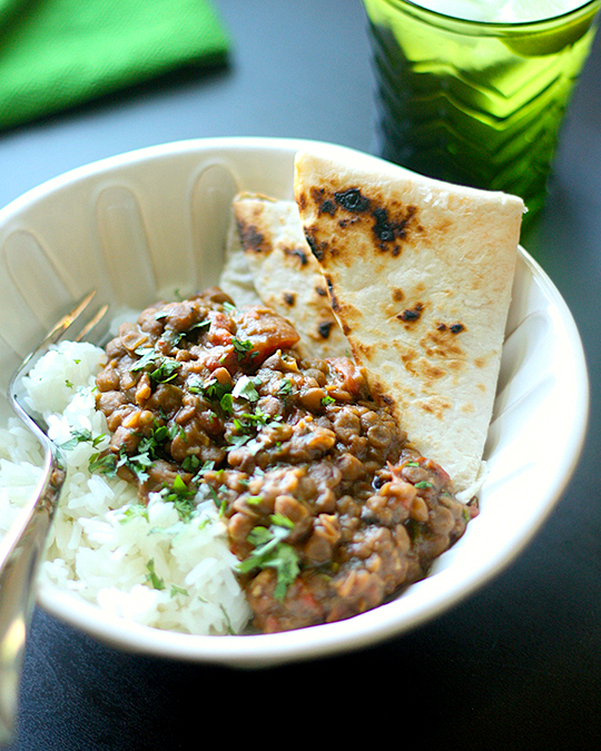 Slow cooker masala over rice with a side of pita.