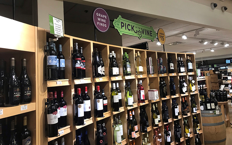 Heinen's Wine Department with signs that read "Grape Wine Finds." "Pick of the Vine," and "Under $15."