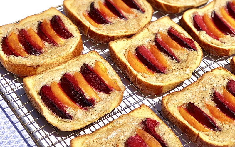 Toast topped with a brown sugar glaze and sliced peaches.