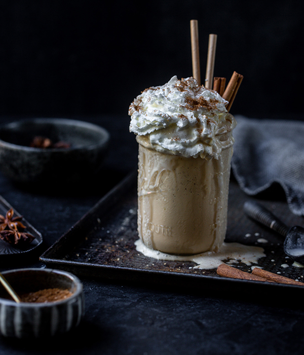 Chai Milkshake with Whipped Cream and Cinnamon Sticks