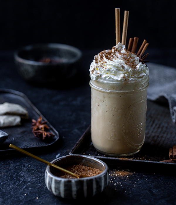 Chai Milkshake with Whipped Cream and Cinnamon Sticks