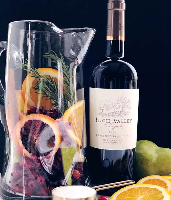 Holiday Sangria in Pitcher with Wine Bottle and Ingredients