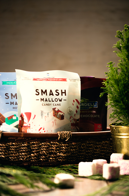 Basket with Smash Mallow candy cane marshmallow bag and a Ghirardelli chocolate bag.