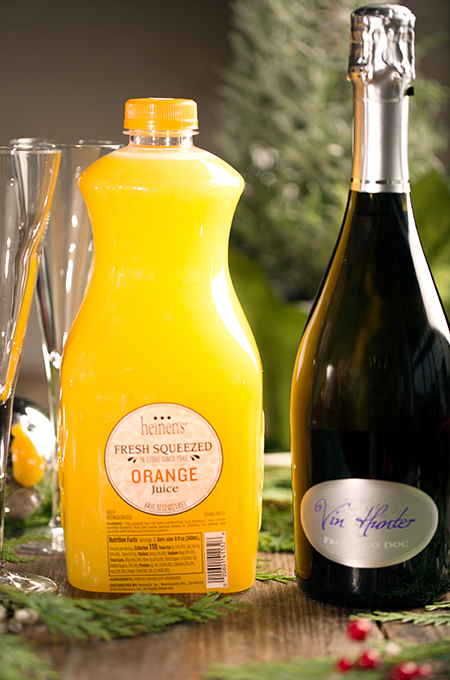Heinen's fresh squeezed orange juice container next to Vin Hunter prosecco.