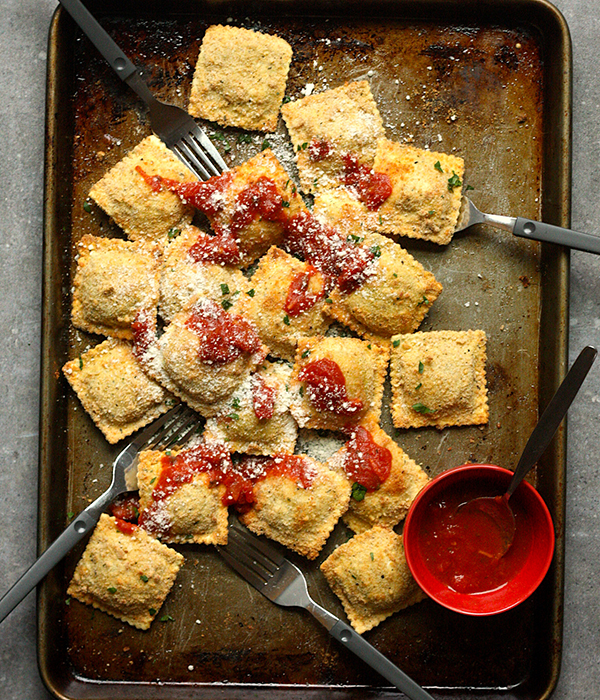 Toasted Chicken Parmesan Ravioli Bites on Baking Sheet with Marinara