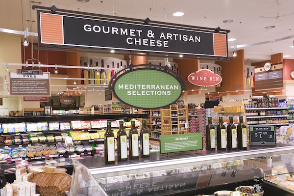 Heinen's Specialty Cheese Department with signs that say: "Gourmet and Artisan Cheese" and "Mediterranean Selections."