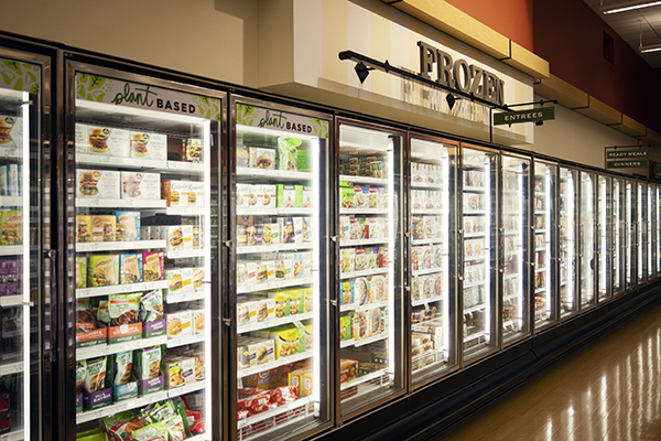 Frozen foods department with tall freezers inside a Heinen's Grocery Store. 