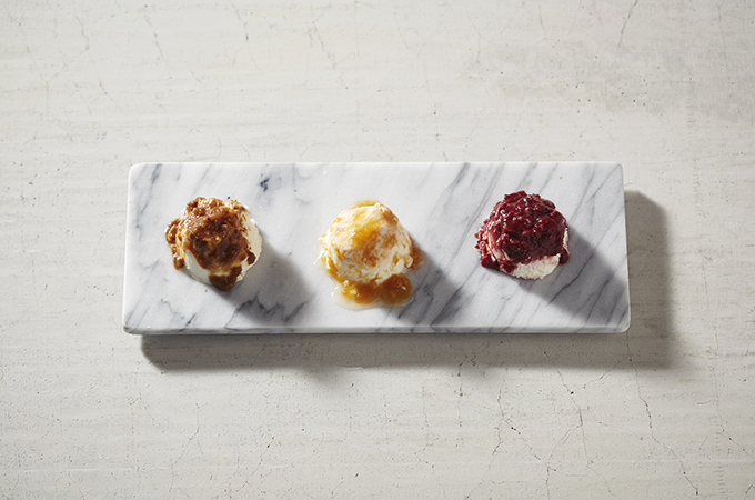 Mackenzie Creamery cheeses on a platter with fruit and nut toppings. 