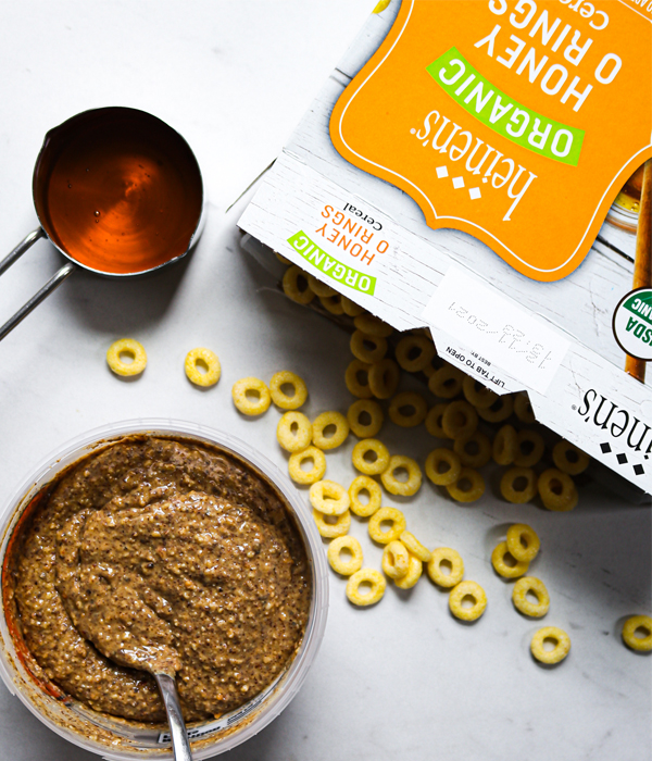 Heinen's honey ring cereal next to honey and fresh ground almond butter.