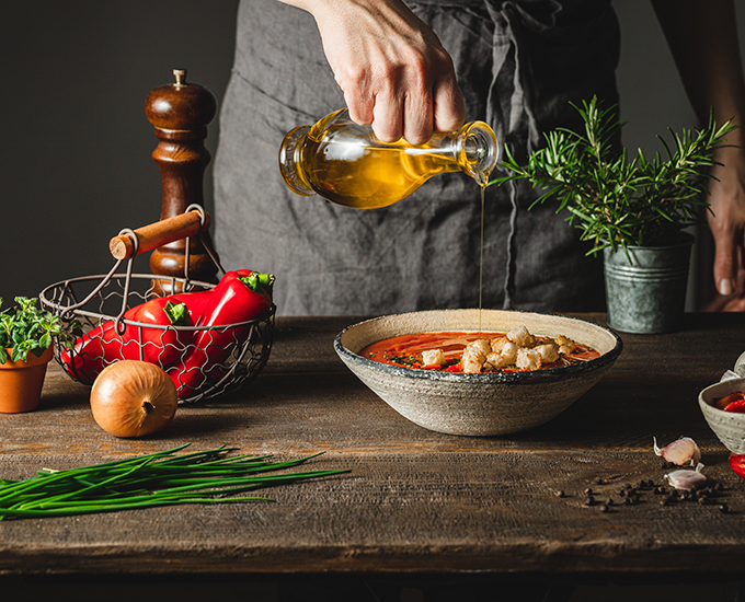 Olive Oil Being Poured Over Cooked Food