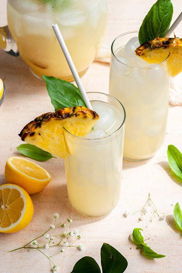 Pineapple lemonades topped with fresh pineapple slices and mint.