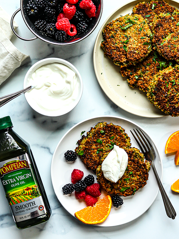 Flat breakfast fritters with a side of raspberries, blackberries and oranges.
