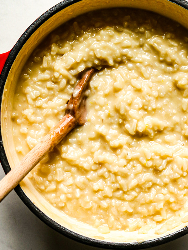 Spread of food including penne pasta with meatballs, ice cream, bagels, and veggies with dip.