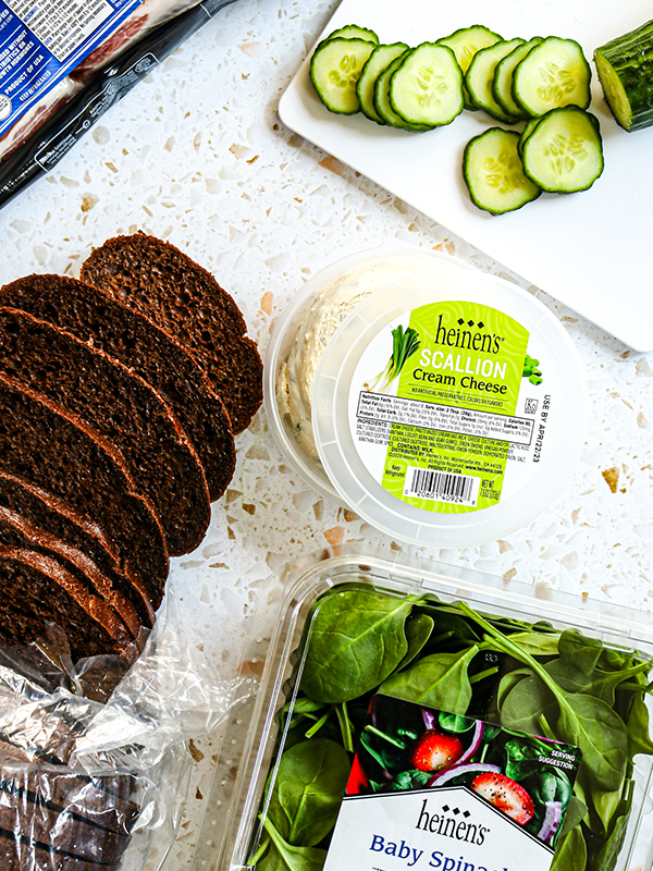 Tea Sandwich ingredients including bread, cream cheese, bacon, cucumber, and baby spinach.