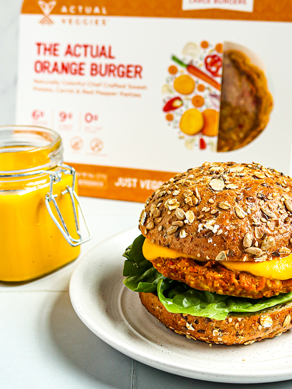 Sweet potato burger on a multigrain bun with orange sauce and lettuce.