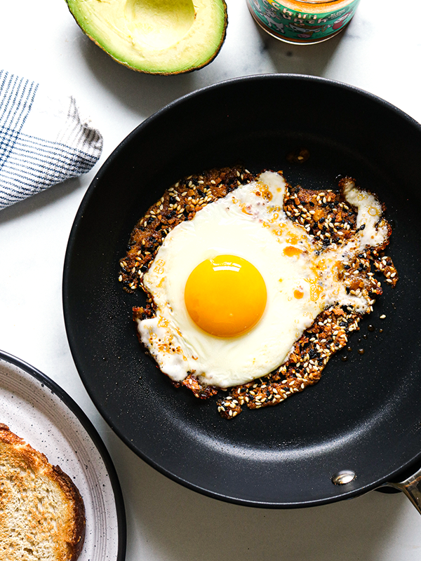 Avocado toast with a fried egg served on a plate.