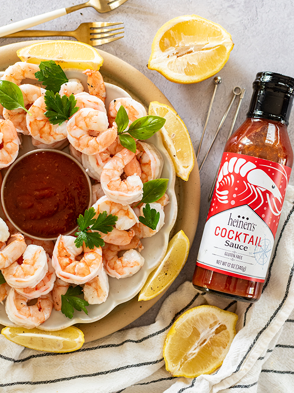 A plate of freshly cooked Heinen's Own Shrimp and cocktail sauce.