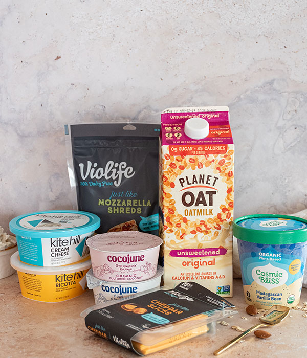 Dairy Free Milk, Cheese, Yogurt, Ice Cream, Cream Cheese and Ricotta Packaging on a Neutral Surface