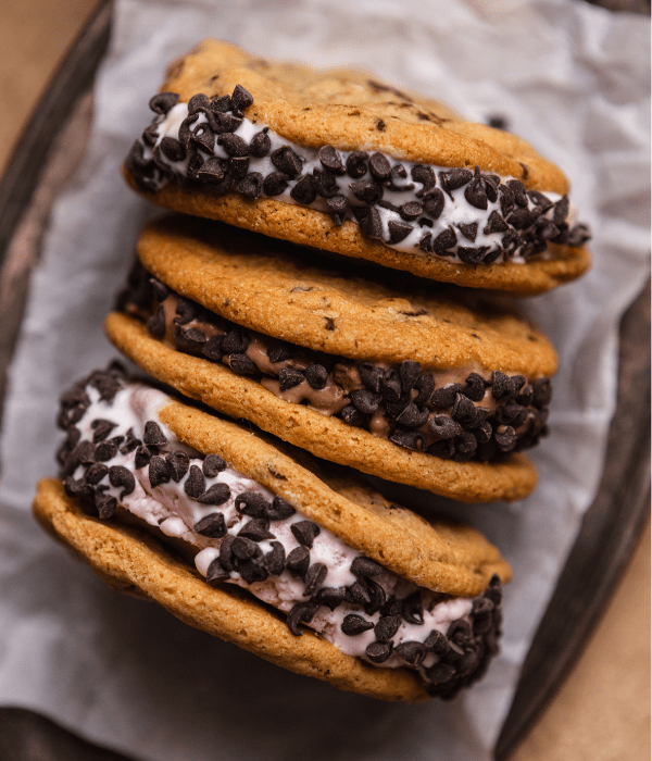 Three DIY Ice cream Sandwiches with chocolate chips around the rim of the ice cream.