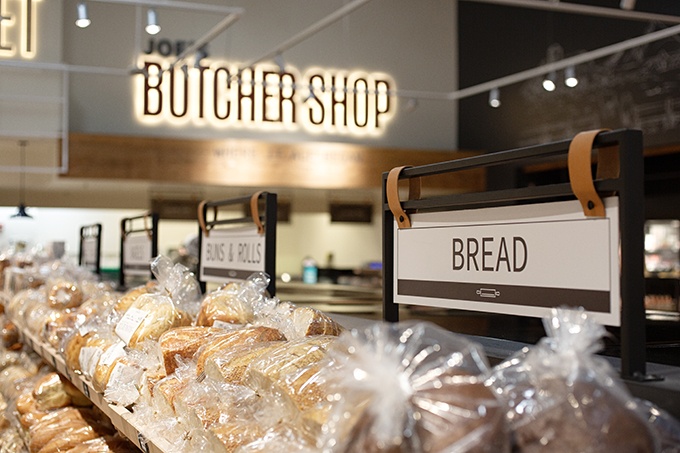 Fresh bread pictured inside a Heinen's store with the sign "Bread" visible.