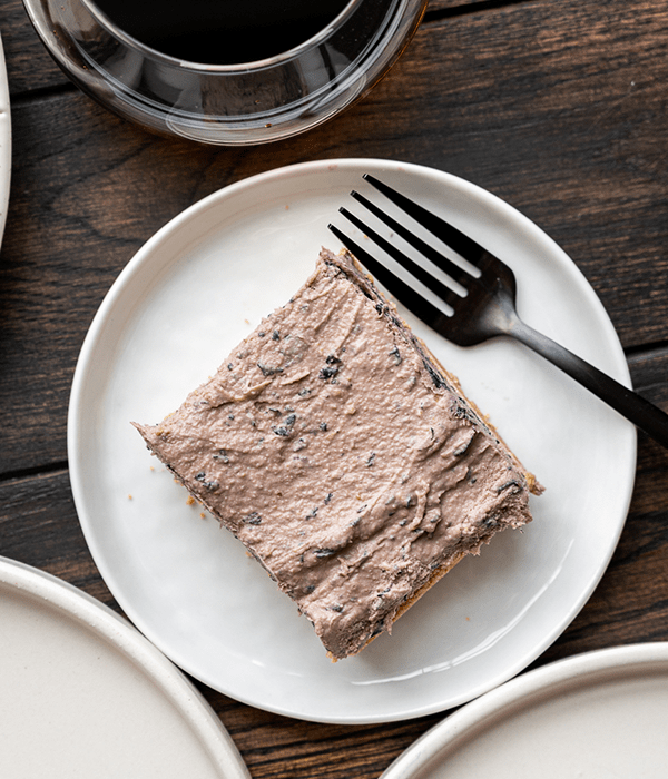 A blueberry Bar on a Round White Plate with a Fork