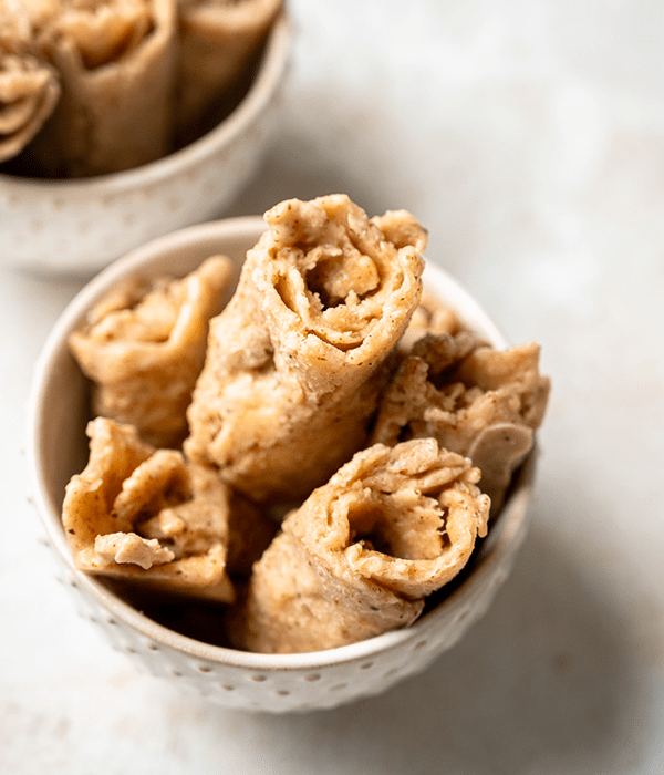 Several Vanilla Almond Frozen Rolls in a Small White Serving Bowl