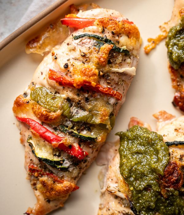 Sliced chicken breast topped with pesto and stuffed with zucchini, tomato, bell pepper, onion, and cheese.