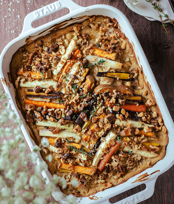 A Top-Down Image of a Creamy Vegetable Root Bake in a White Casserole Dish