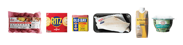 Spread of ingredients including, Dutch potatoes, Ritz crackers, Old Bay seasoning, fresh cod, pinot grigio, and chopped parsley.