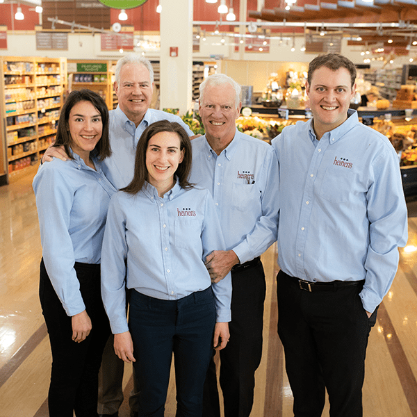 The Third and Fourth Generation of the Heinen Family Standing in a Heinen Store