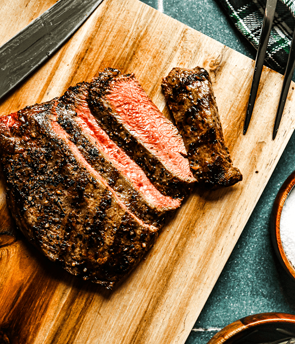 Heinen's Premium Grilled Flat Iron Steak on a Cutting Board