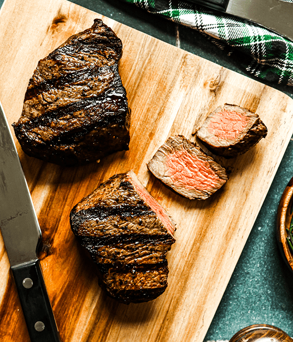 Two Heinen's Grilled Premium Sirloin Fillets on a Cutting Board