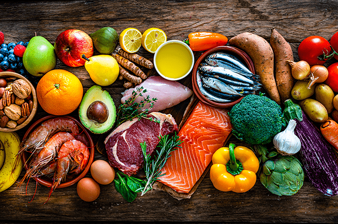A Top Down Image of Fresh Fruits, Vegetables, Seafood, and Red Meat