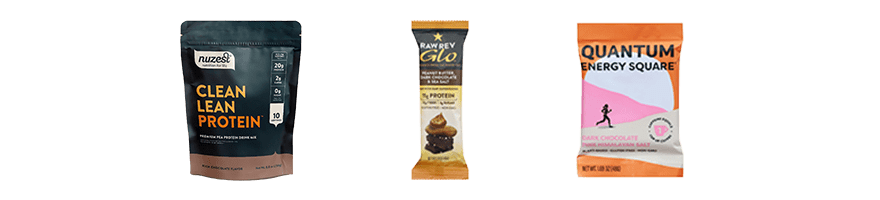 Plant-based protein powders and bars including Nuzest protein powder, Raw Rev Glo bar, and dark chocolate Quantum Energy Square.