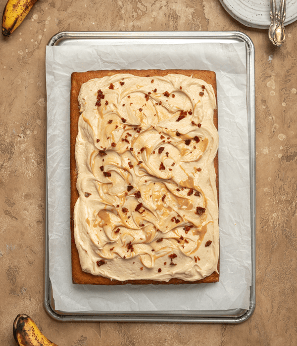 Banana sheet cake with peanut butter frosting and bacon crumble topping