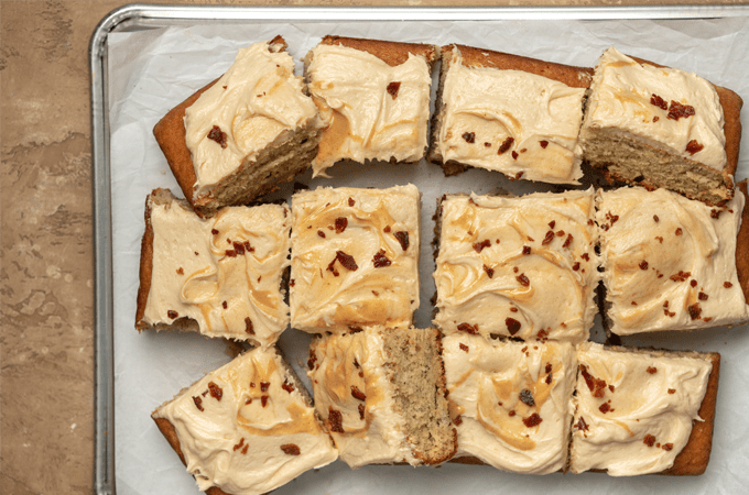 Slices of Banana Cake with Peanut Butter Frosting and Bacon Topping