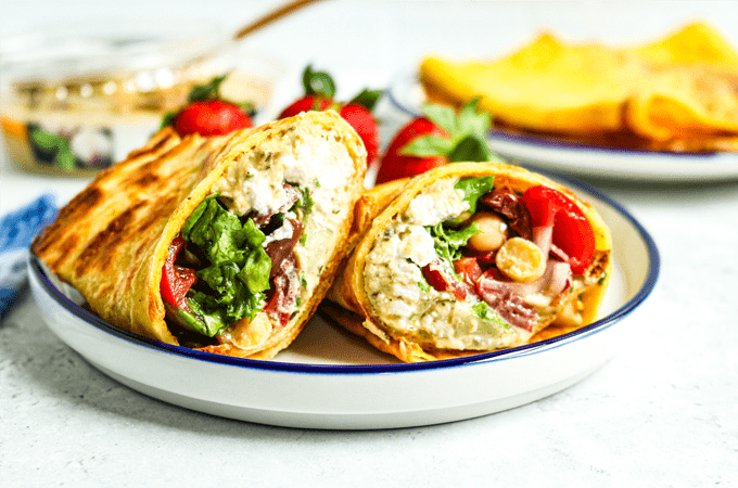 Sliced Mediterranean hummus cottage cheese egg wrap