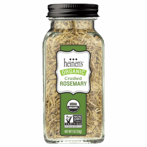 Small glass jar of organic crushed rosemary.