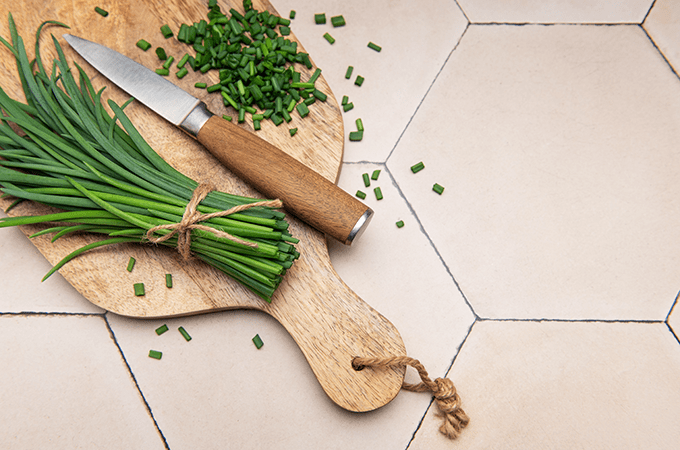 A Bundle of Fresh Chives on a Cutting Board