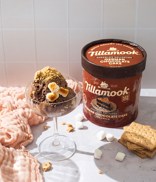 Tillamook German Chocolate Cake Ice Cream with a dessert glass of ice cream topped with marshmallows and graham cracker crumbs