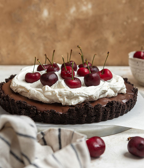 No-Bake Chocolate Cherry Tart topped with cherries