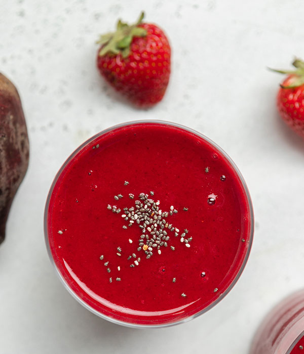 Strawberry vanilla beet smoothie with strawberries and a beet