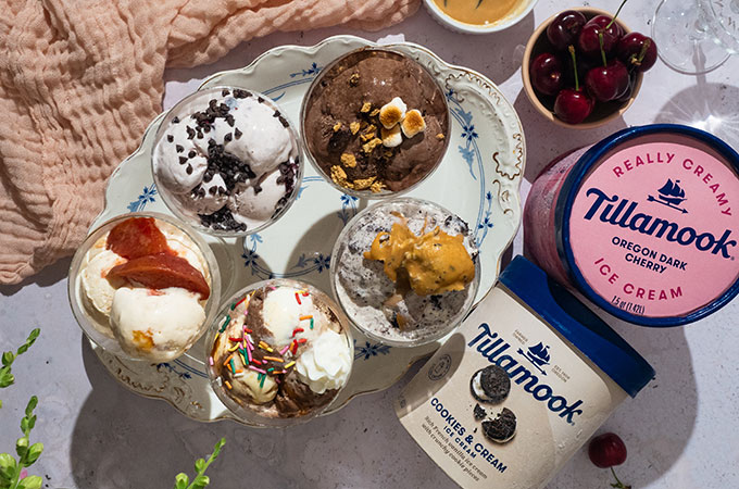 Five ice cream sundaes in dessert glasses, Tillamook Oregon Dark Cherry and Tillamook Cookies and Cream Ice Cream on the side