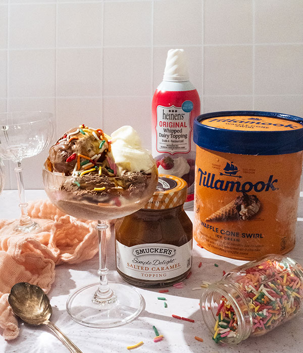 Tillamook Waffle Cone Swirl Ice Cream, Heinen's Whipped Dairy Topping, Smucker's Caramel Topping, and a sundae with the ice cream, caramel, whipped dairy topping and sprinkles
