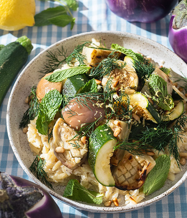 Bowl of Ricotta Lemon Orzo topped with grilled eggplant, zucchini, and herbs