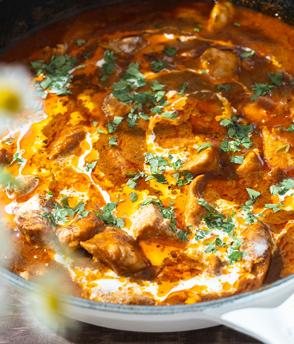 Pan of butter masala chicken simmer sauce with chicken