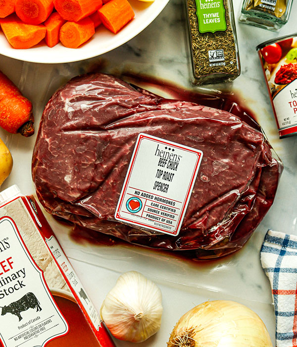 Heinen's Beef Chuck Top Roast, onions, thyme leaves, culinary stock, tomato paste, and carrots